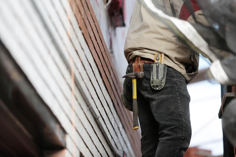 Tradesman wearing a tool belt on a work site